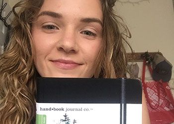 Melissa Gordon, holding a sketchbook