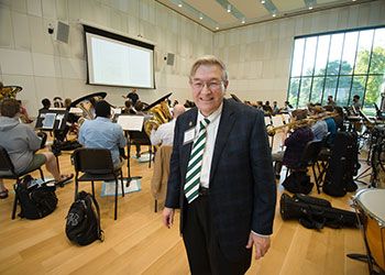 James Billman with an orchestra in the background James Billman with an orchestra in the background