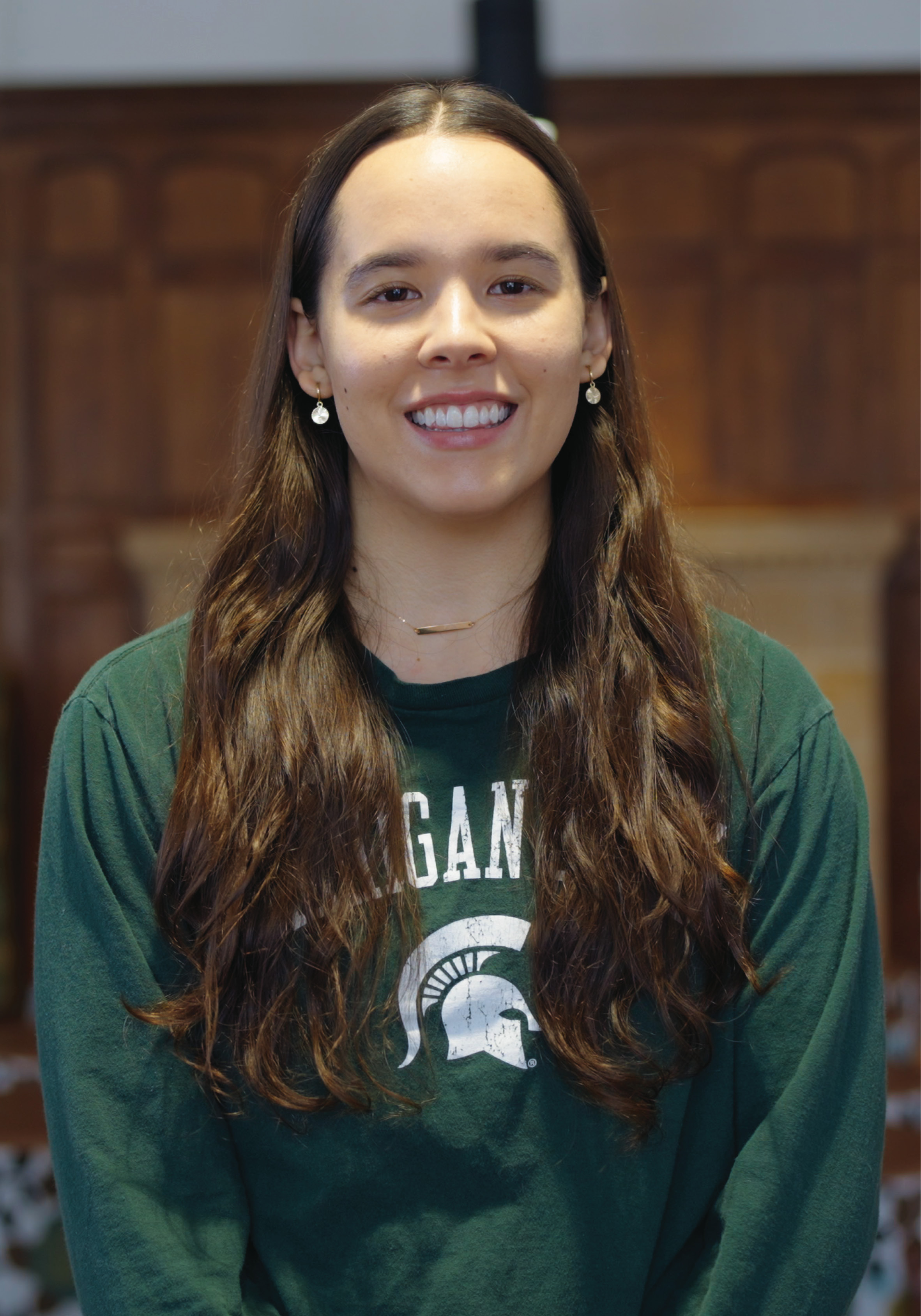 Portrait of MSU Honors College senior Sloane Barlow in a green Michigan State long sleeved t-shirt.