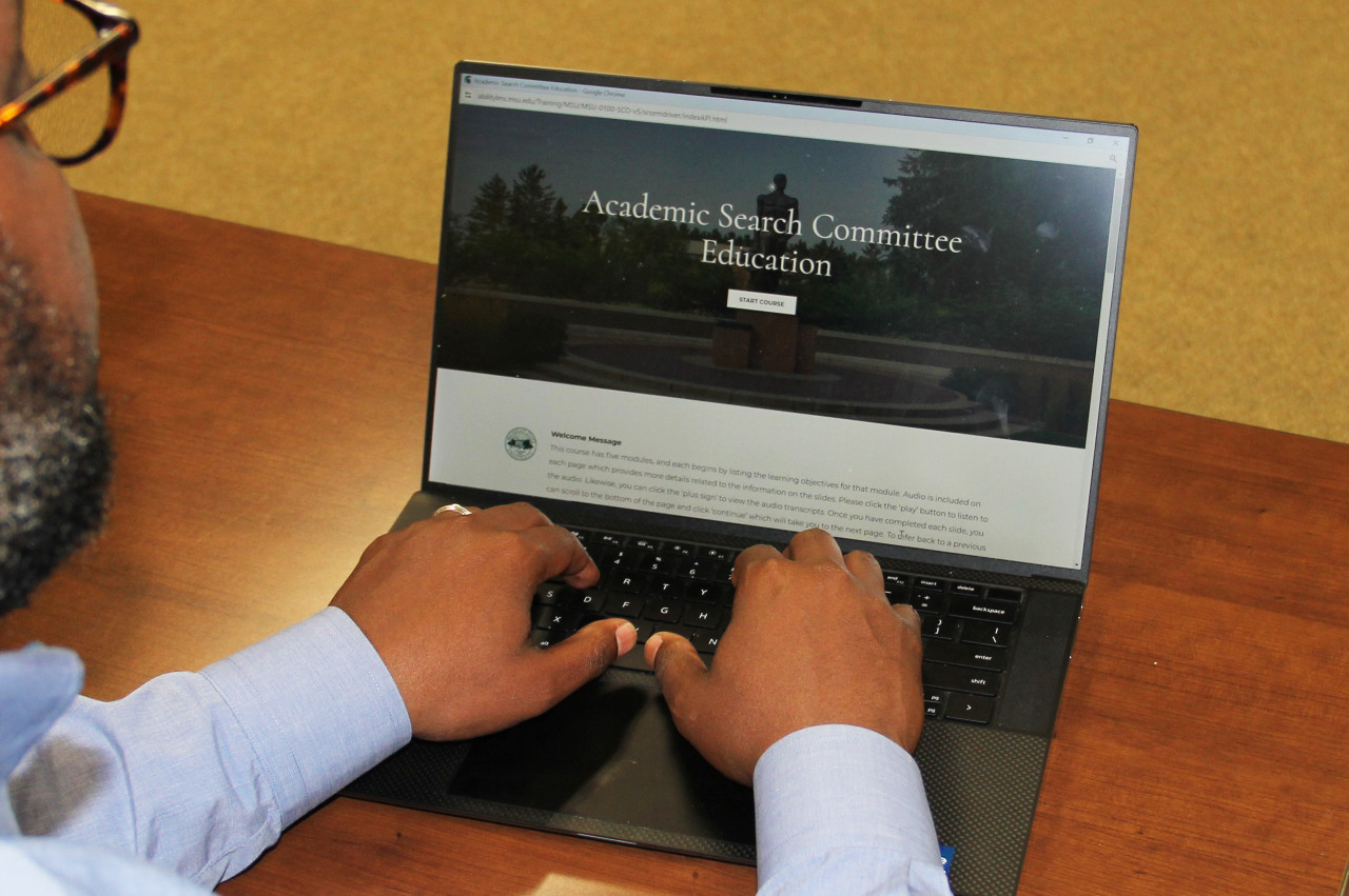 Person typing on a laptop.