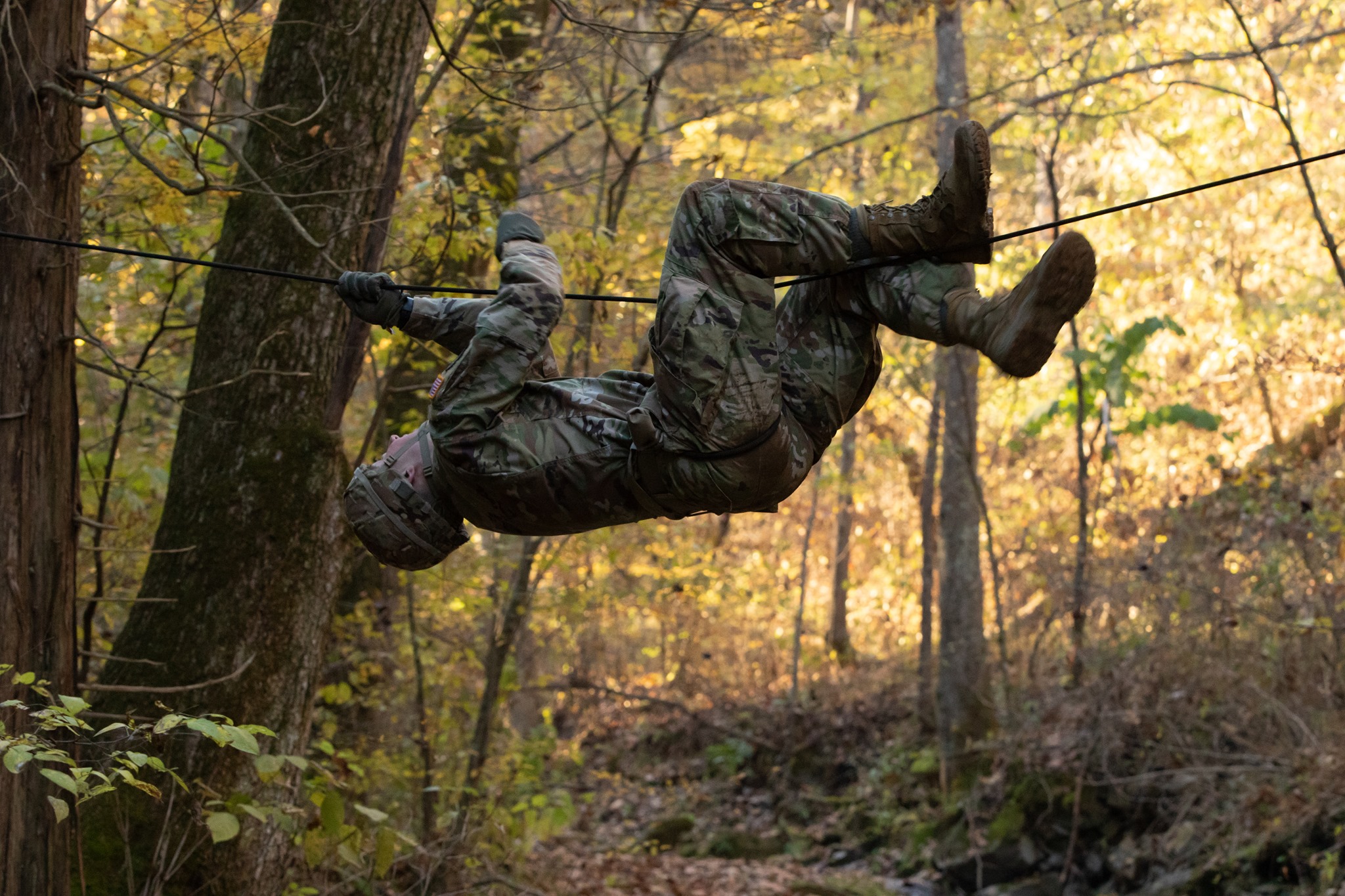Cadet hanging from a rope completing a challenge