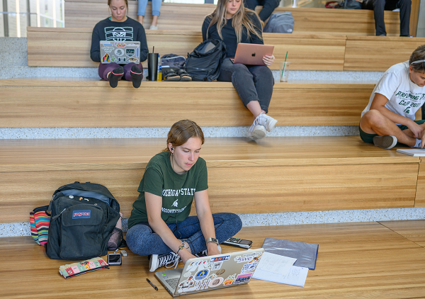 Student studying on stairs
