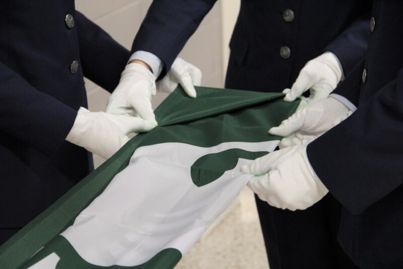 U.S. Air Force ROTC cadets folding Spartan flags