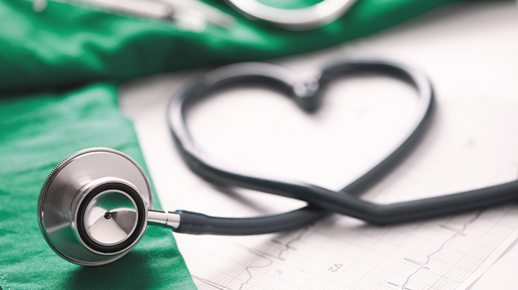 Stethoscope arranged in the shape of a heart on top of medical charts, representing Michigan State University’s health humanities major, which explores the connections between healthcare, human experience, ethics, culture, and well-being through the arts and humanities.