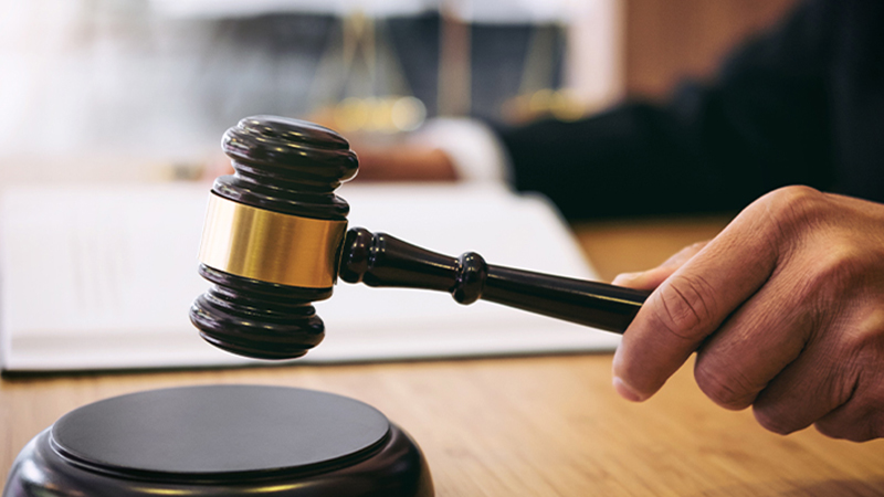 Close-up of a judge’s gavel striking a sound block, symbolizing justice, ethics, and critical reasoning in the Michigan State University law and philosophy major, where students explore legal systems, moral theory, and the foundations of public policy.