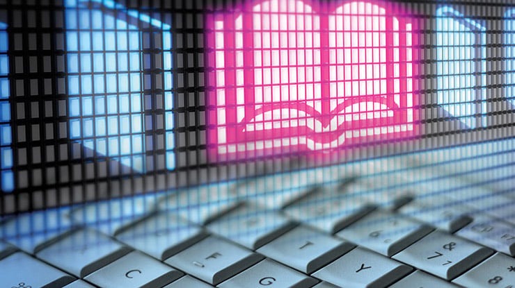 Close-up of a keyboard and an icon of a book, representing the professional writing major.