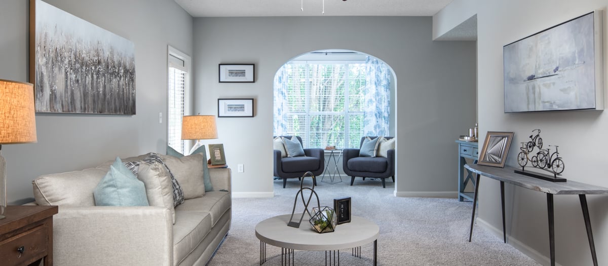 Spacious living room with optional sunroom and cozy furniture at MAA Briarcliff luxury apartments in Atlanta, GA