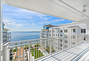 Outdoor patio with white guardrails with a waterfront view at MAA Breakwater luxury apartments in Tampa, FL