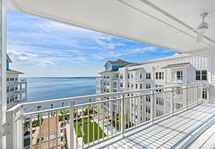 Outdoor patio with white guardrails with a waterfront view at MAA Breakwater luxury apartments in Tampa, FL