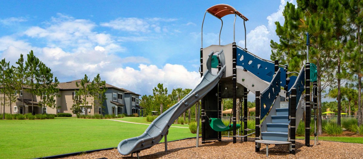 Playground by Pond at MAA Hampton Preserve luxury apartment homes in Tampa, FL