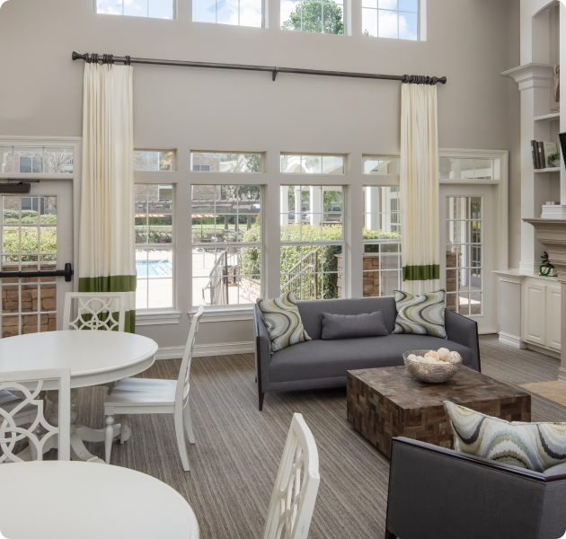 Community clubhouse with large picture windows and lounge areas at MAA Barrett Creek luxury apartments in Marietta, GA