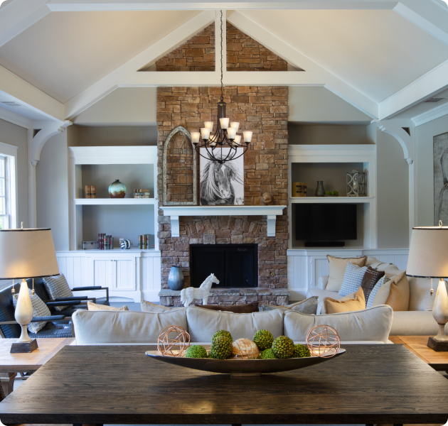 Luxurious community clubhouse lounge sitting area next to a rustic brick fireplace and built in shelves at MAA Berkeley Lake luxury apartments in Duluth, GA