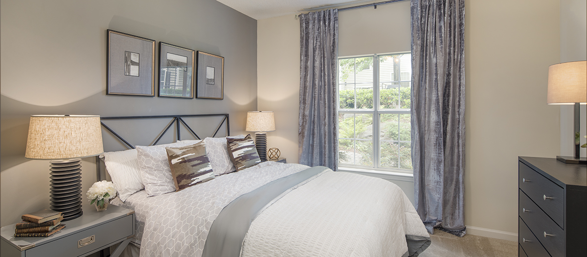 Cozy bedroom with natural light and modern furniture at MAA Briarcliff luxury apartments in Atlanta, GA