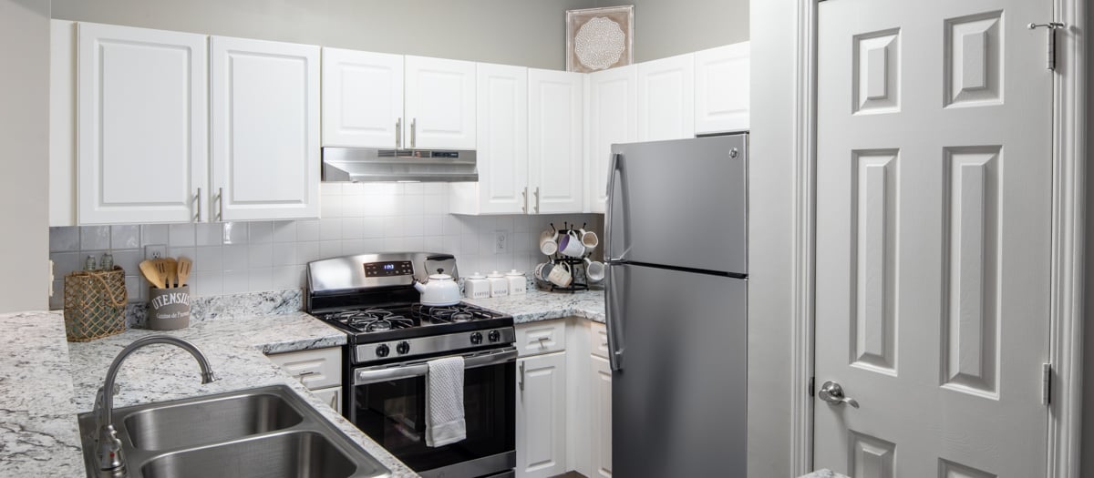 Upscale modern kitchen with stainless steel appliances and granite countertops at MAA Briarcliff luxury apartments in Atlanta, GA