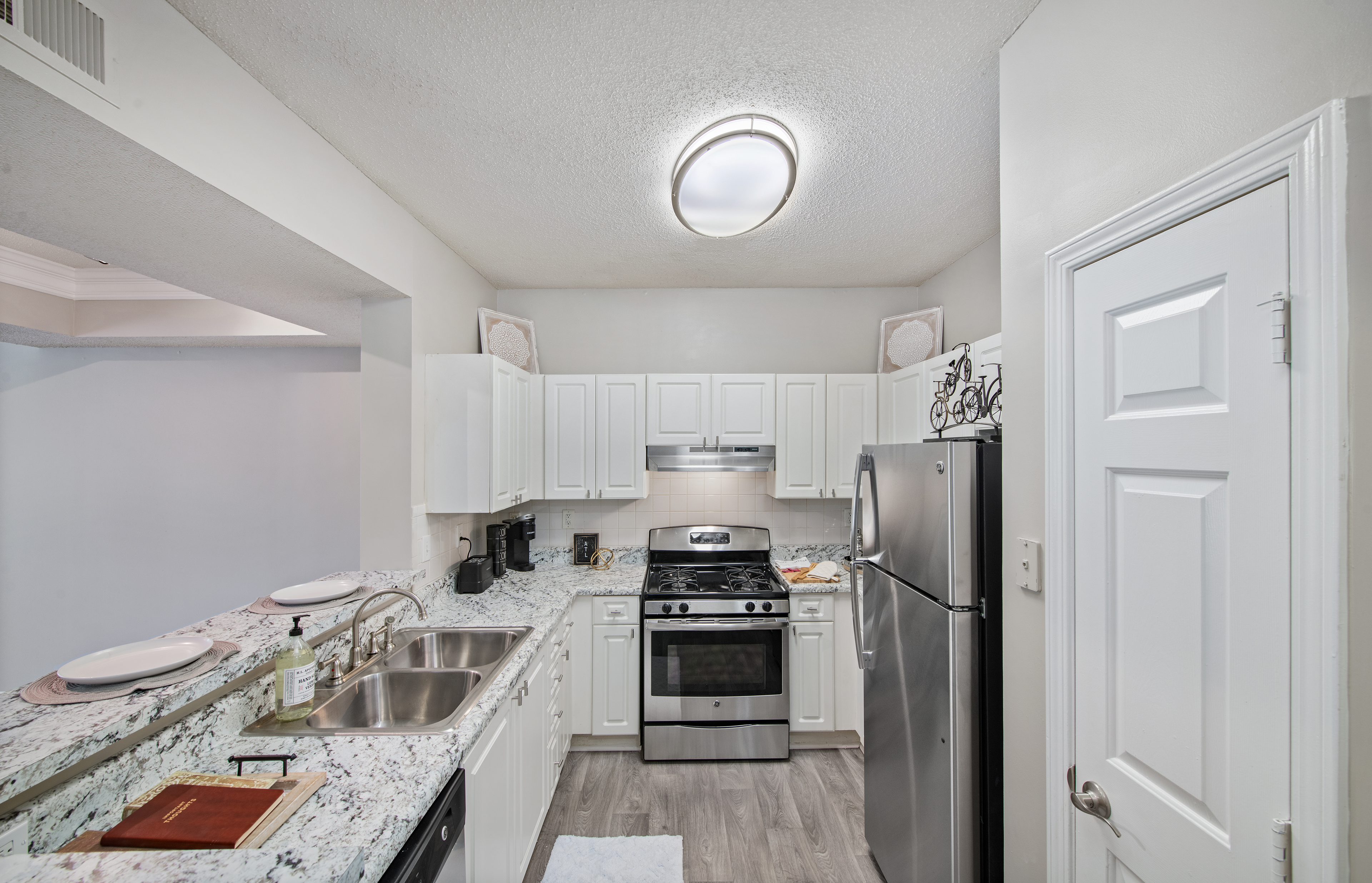 Modern kitchen with stainless steel appliances and bar top counter at MAA Briarcliff luxury apartments in Atlanta, GA