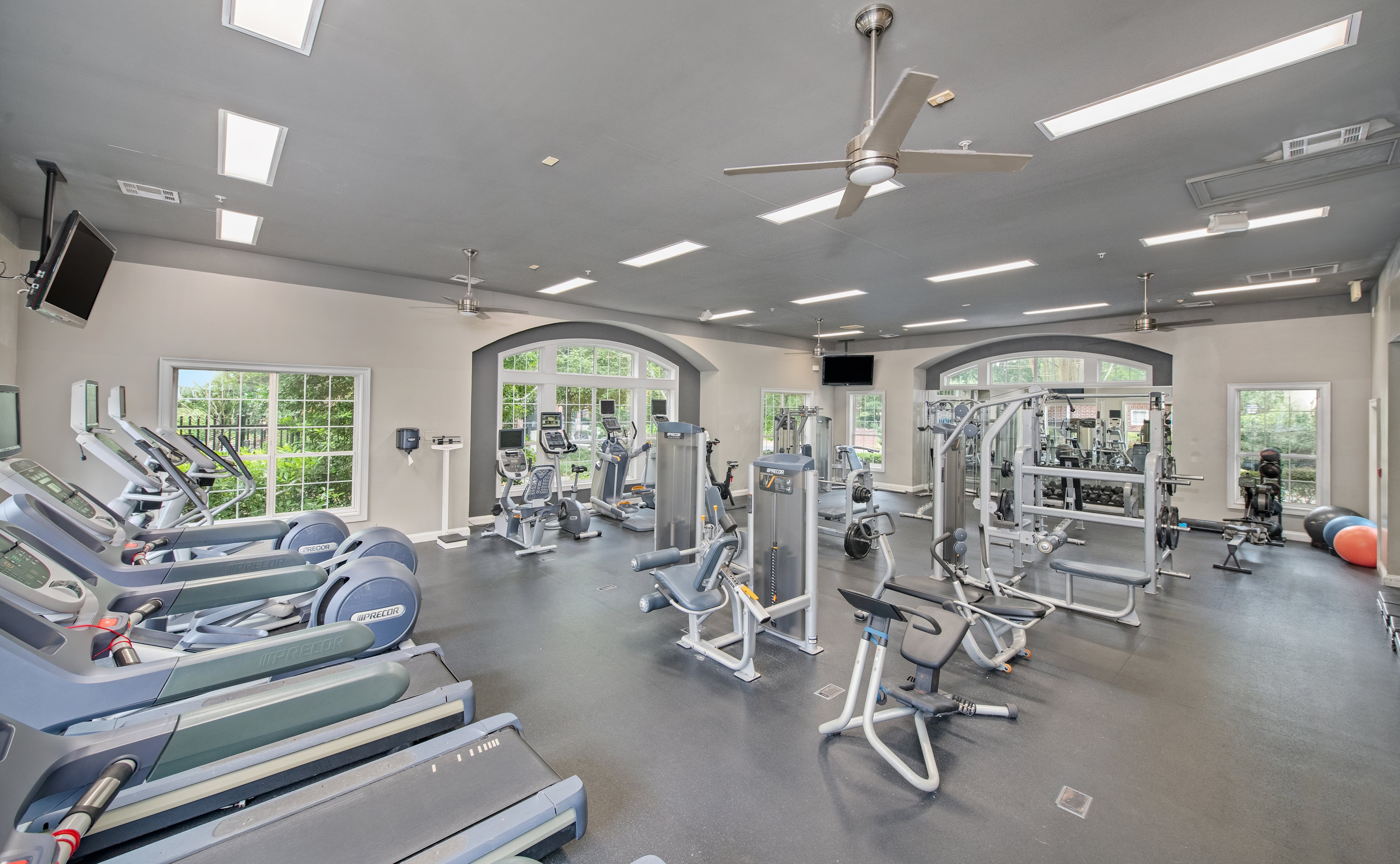 Front entrance view of fitness center with stationary bikes, treadmills and weight machines at MAA Briarcliff luxury apartments in Atlanta, GA