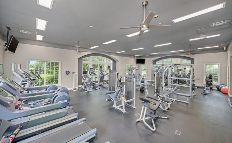 Front entrance view of fitness center with stationary bikes, treadmills and weight machines at MAA Briarcliff luxury apartments in Atlanta, GA