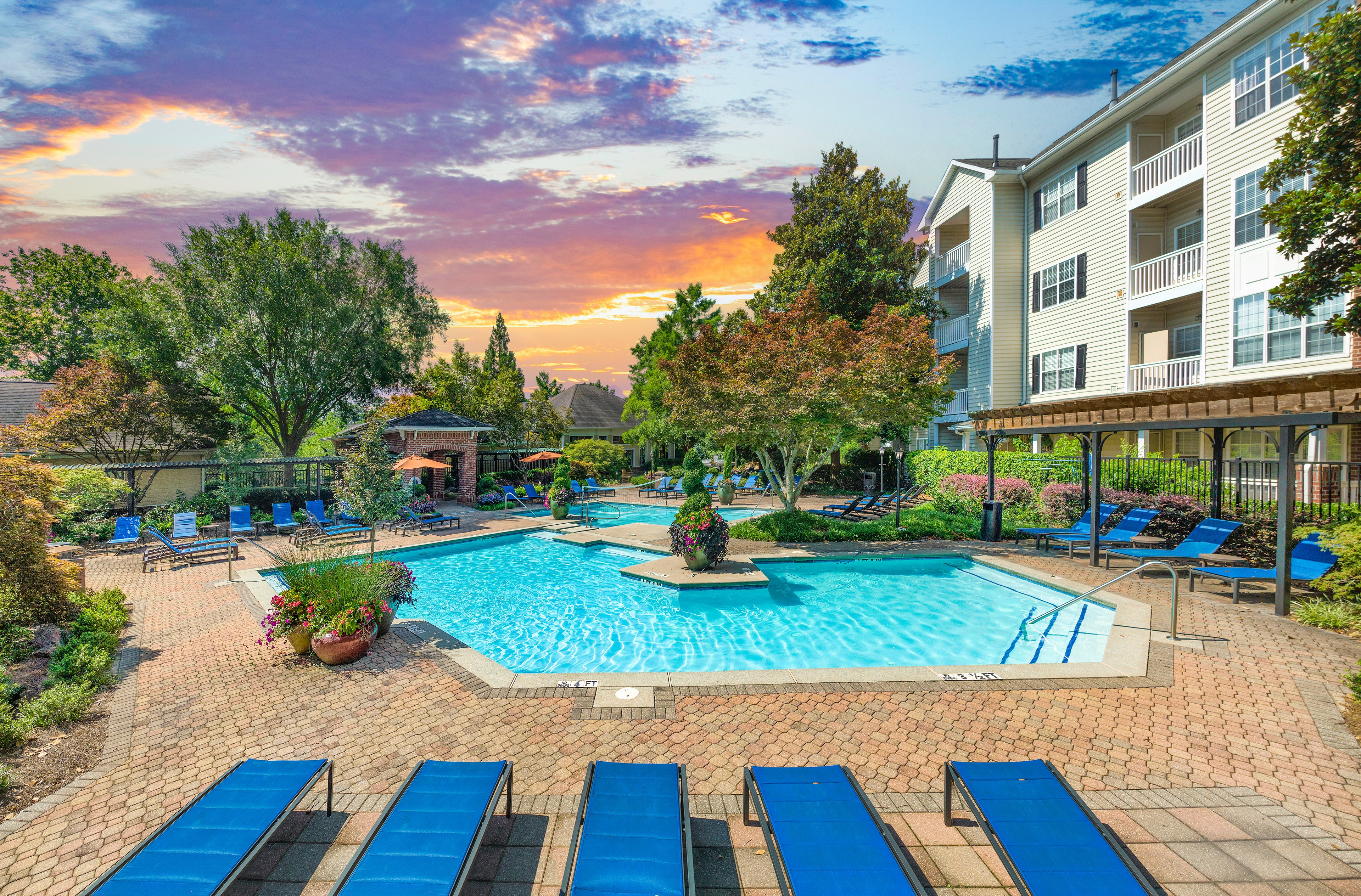 Main swimming pool with lounge chairs and a pergola at MAA Briarcliff luxury apartments in Atlanta, GA