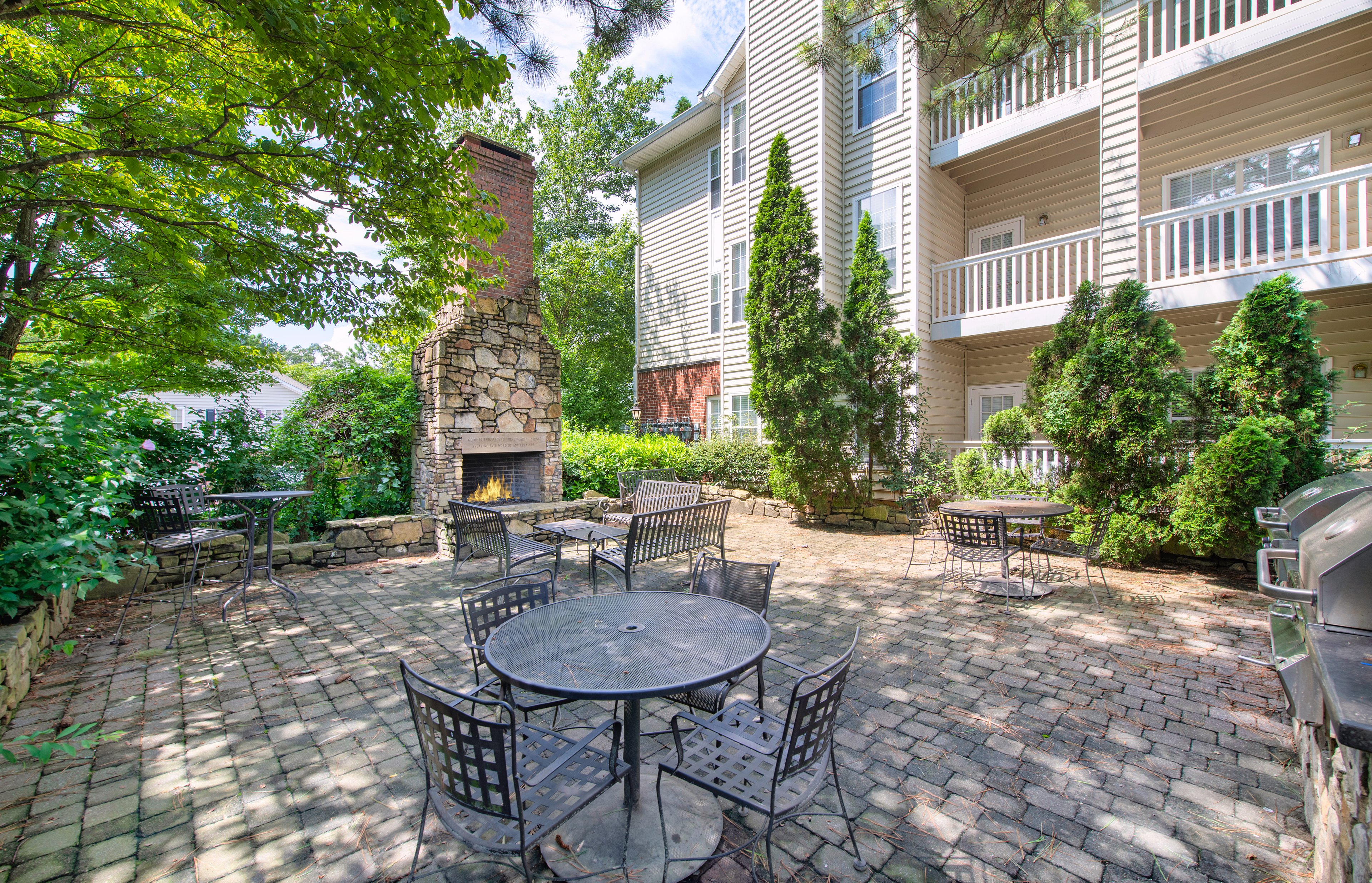 Patio area with outdoor grilling station & fireplace at MAA Briarcliff luxury apartments in Atlanta, GA