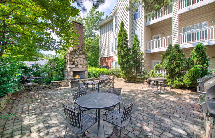 Patio area with outdoor grilling station & fireplace at MAA Briarcliff luxury apartments in Atlanta, GA