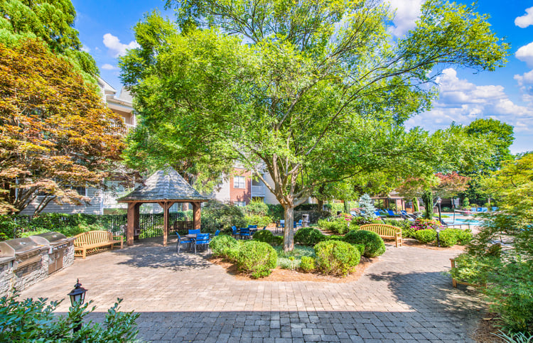 Courtyard with a gazebo, tables and chairs next to the pool at MAA Briarcliff luxury apartments in Atlanta, GA