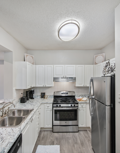 Modern kitchen with white cabinets and stainless steel appliances at MAA Briarcliff luxury apartments in Atlanta, GA