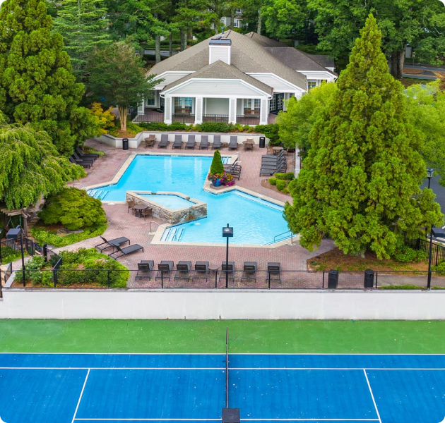 Aerial view of community tennis court and swimming pool at MAA Brookhaven luxury apartments in Atlanta, GA