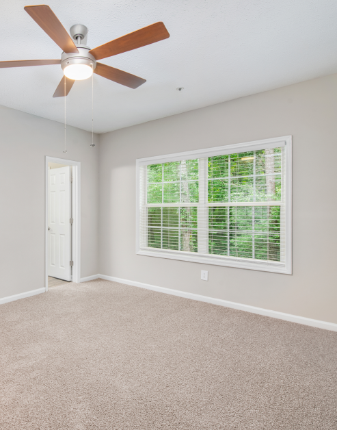 Spacious empty carpeted bedroom with picture windows at MAA Brookhaven luxury apartments in Atlanta, GA