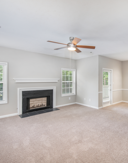 Spacious living room with fireplace and ceiling fan at MAA Brookhaven luxury apartments in Atlanta, GA