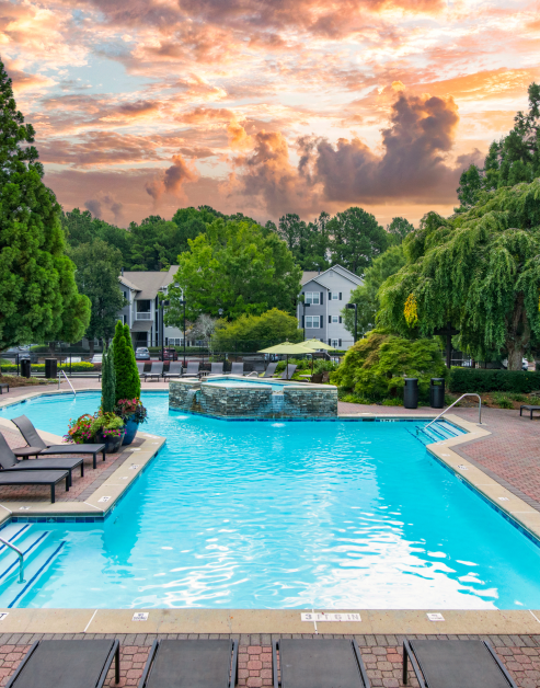 Beautiful swimming pool surrounded by lush greenery at MAA Brookhaven luxury apartments in Atlanta, GA