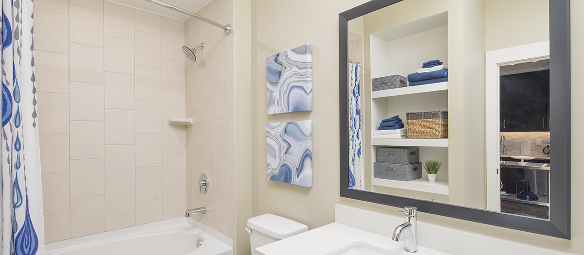 Light colored bathroom with shower and sink with vanity at MAA Centennial Park luxury apartments in Atlanta, GA