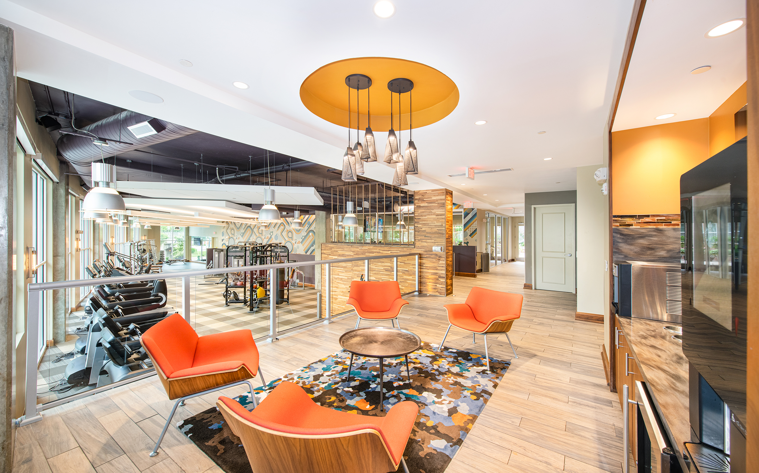 Coffee bar with chairs next to fitness center at MAA Centennial Park luxury apartments in Atlanta, GA