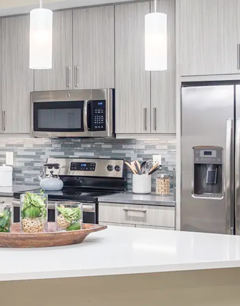 Kitchen with stainless steel appliances at MAA Centennial Park luxury apartments in Atlanta, GA