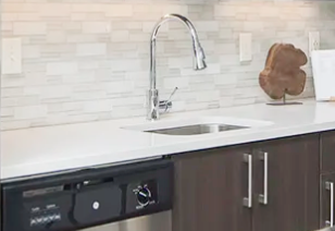 Spacious kitchen with light countertops and brown cabinets at MAA Centennial Park luxury apartments in Atlanta, GA