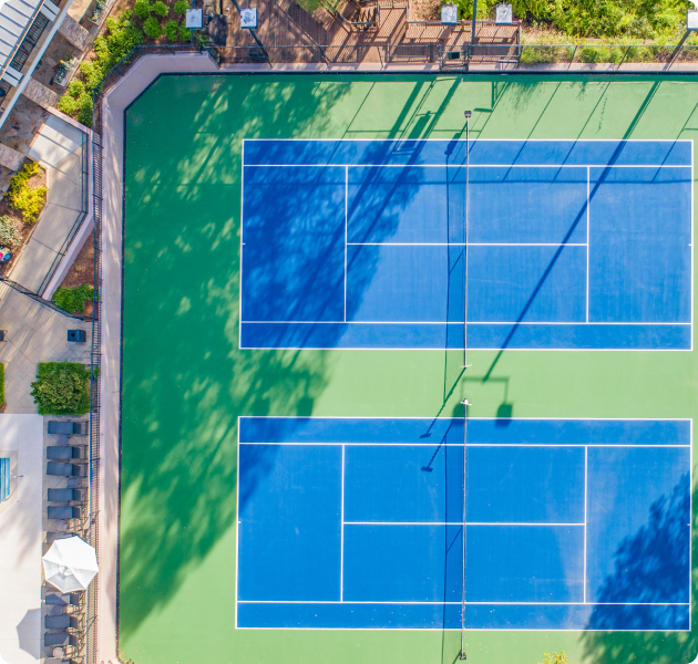 Aerial top view of community tennis courts next to pool area at MAA Chastain luxury apartments in Atlanta, GA