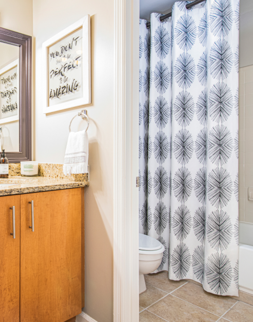 Stylish bathroom with marble countertop, shower tub with tile floors at MAA Chastain luxury apartments in Atlanta, GA