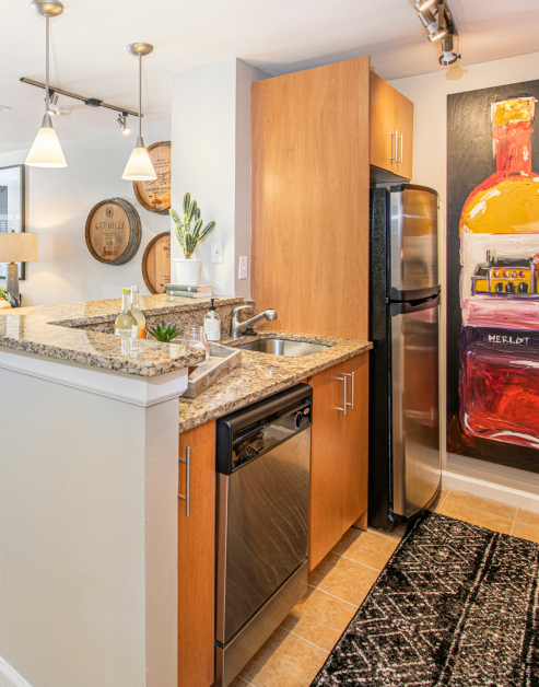 Upscale model kitchen with granite countertop, tile flooring and upgraded appliances at MAA Chastain luxury apartments in Atlanta, GA