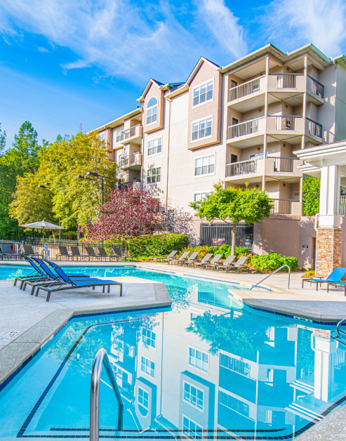Relaxing resort-style wading pool surrounded by lush trees at MAA Chastain luxury apartments in Atlanta, GA
