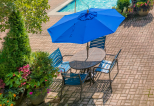Poolside patio chairs and table at MAA Dunwoody luxury apartments in Atlanta, GA