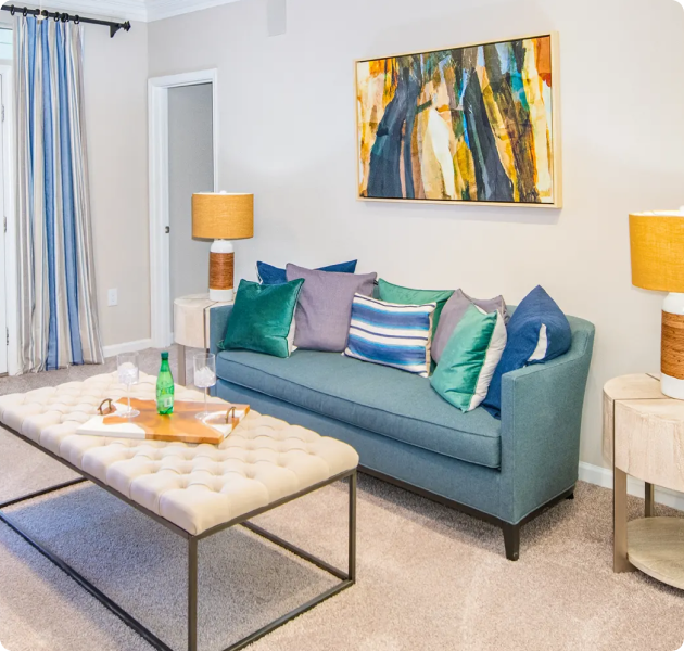 Apartment model living room with colorful modern décor with sofa couch and ottoman at MAA Gardens luxury apartments in Atlanta, GA