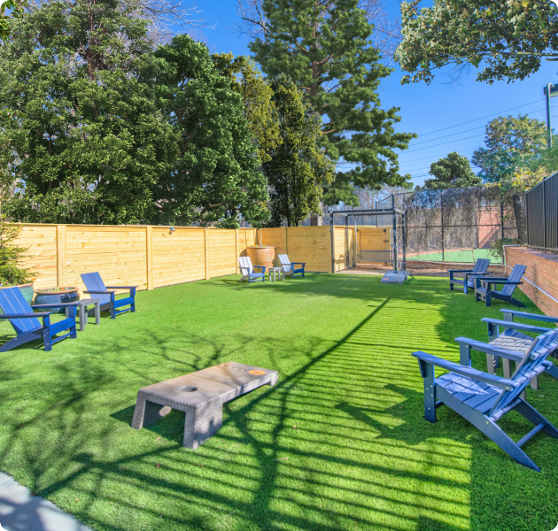 Relaxing courtyard with lounge chairs, cornhole boards and swing seats at MAA Glen luxury apartments in Atlanta, GA