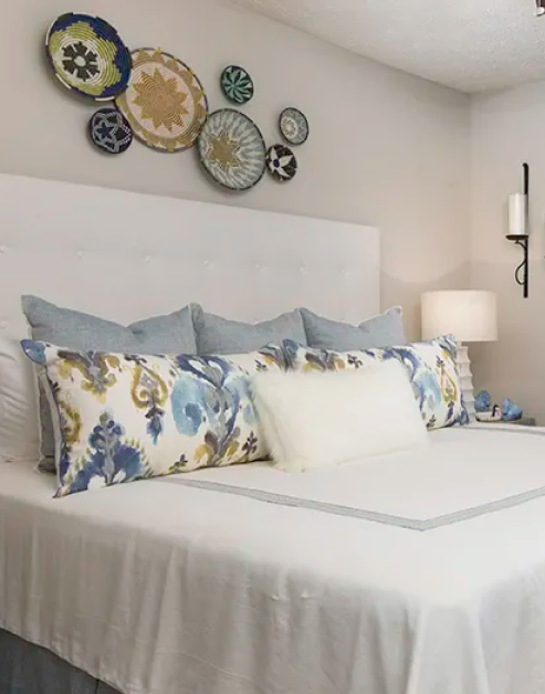 Model bedroom with white bedding and accent pillows at MAA Glen luxury apartments in Atlanta, GA