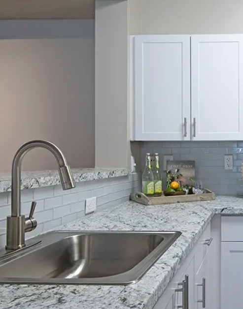 Upscale modern kitchen with granite countertops, bar top and upgraded appliances at MAA Glen luxury apartments in Atlanta, GA
