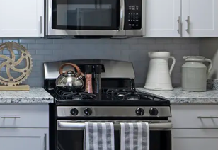 Modern kitchen with upgraded microwave and stove at MAA Glen luxury apartments in Atlanta, GA