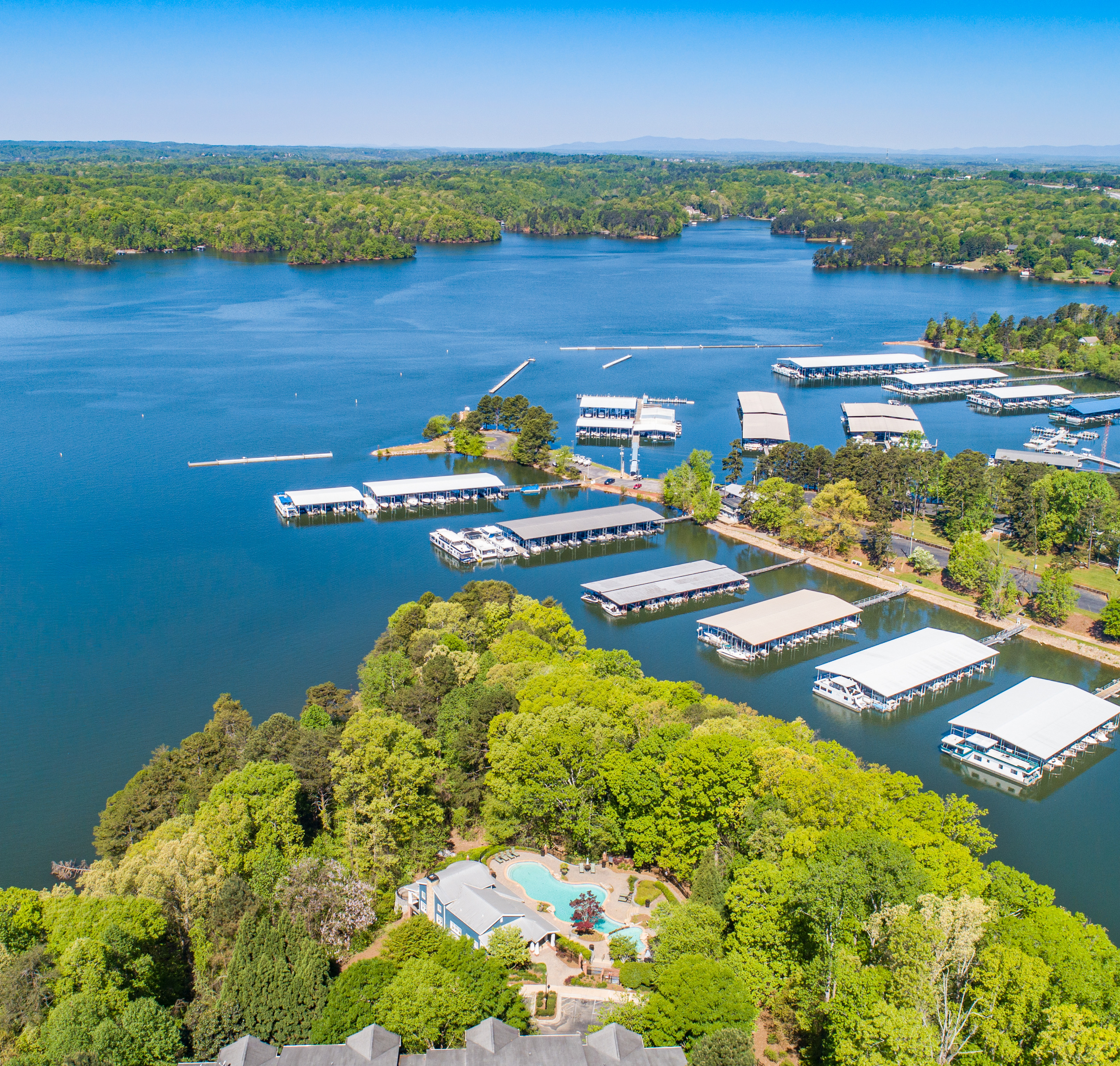 Aerial view of community boat docks on lake waters at MAA Lake Lanier luxury apartments in Gainesville, GA