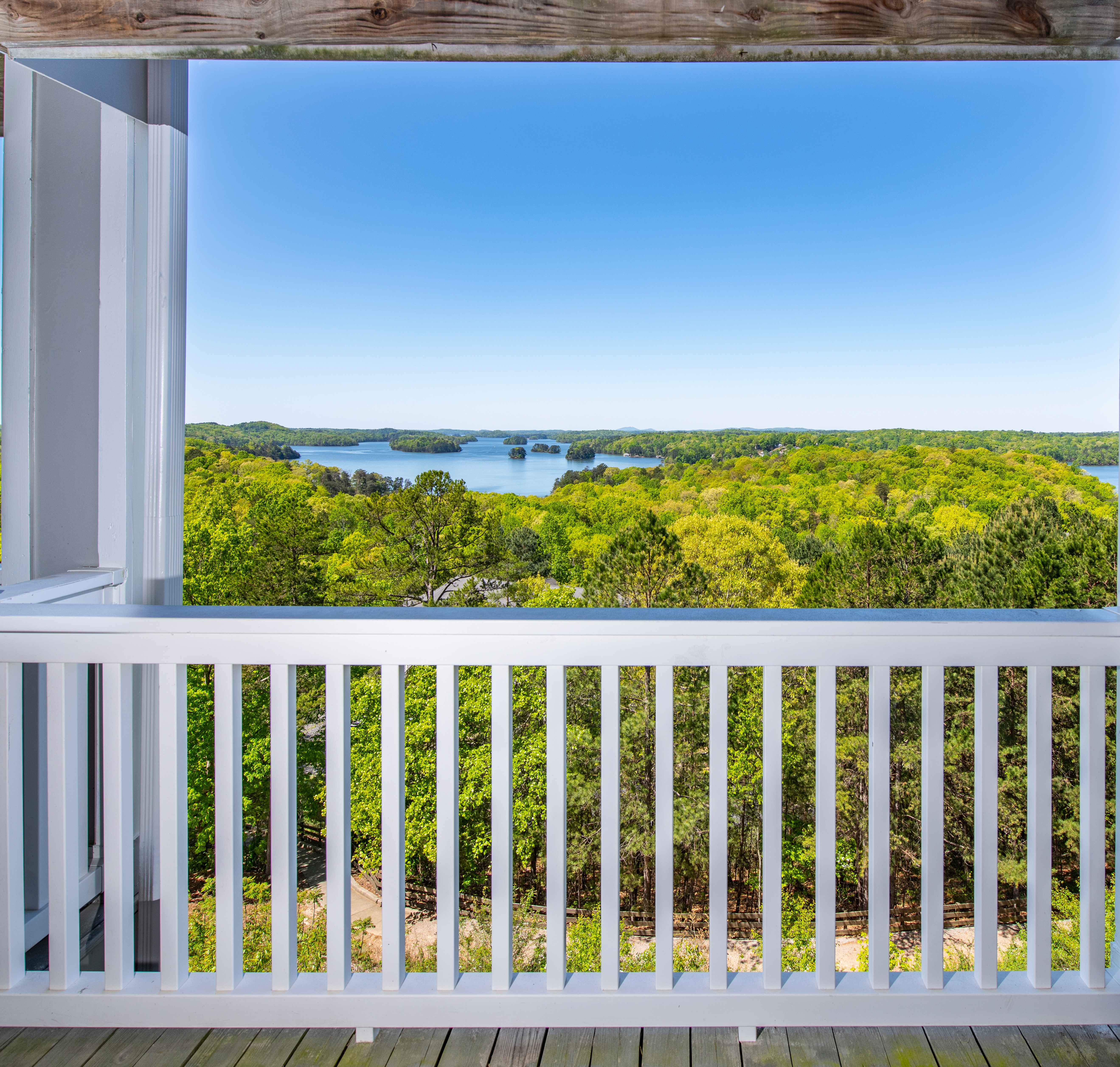 Apartment balcony view with white fence railing and lake views at MAA Lake Lanier luxury apartments in Gainesville, GA