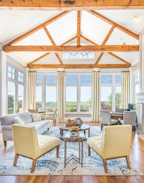 Luxurious community clubhouse with wood beam high ceilings and panorama window views at MAA Lake Lanier luxury apartments in Gainesville, GA