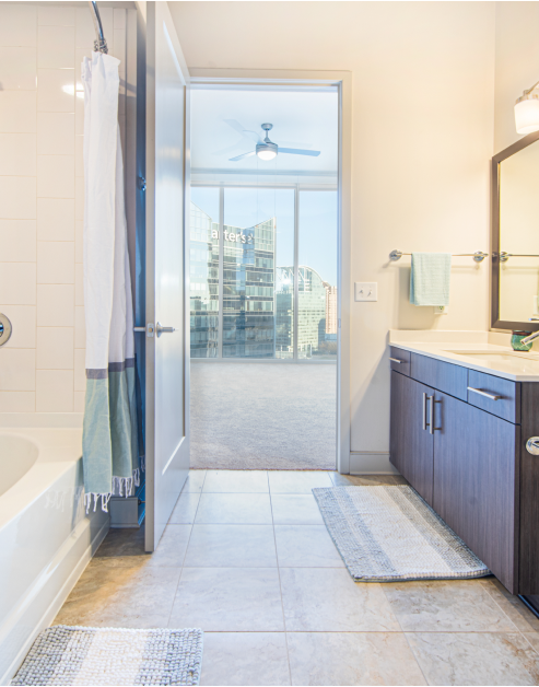 Tiled bathroom side view of door to bedroom at MAA Lenox luxury apartments in Atlanta, GA