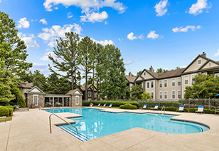 Wide view of swimming pool next to apartment complex at MAA McDaniel Farm luxury apartments in Duluth, GA