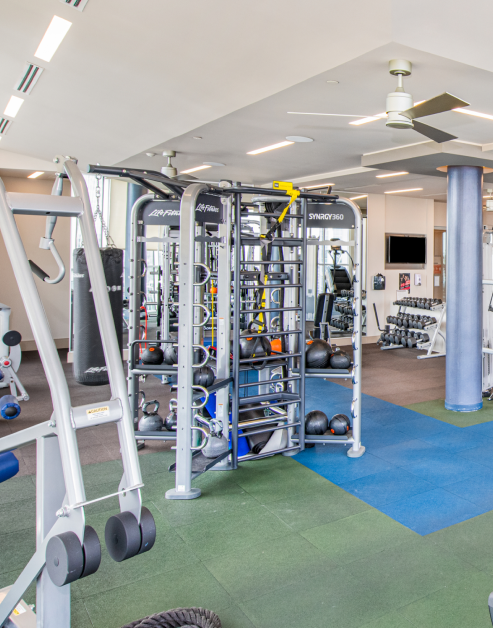 Fitness center weight machine stations with ceiling fans at MAA Midtown luxury apartments in Atlanta, GA